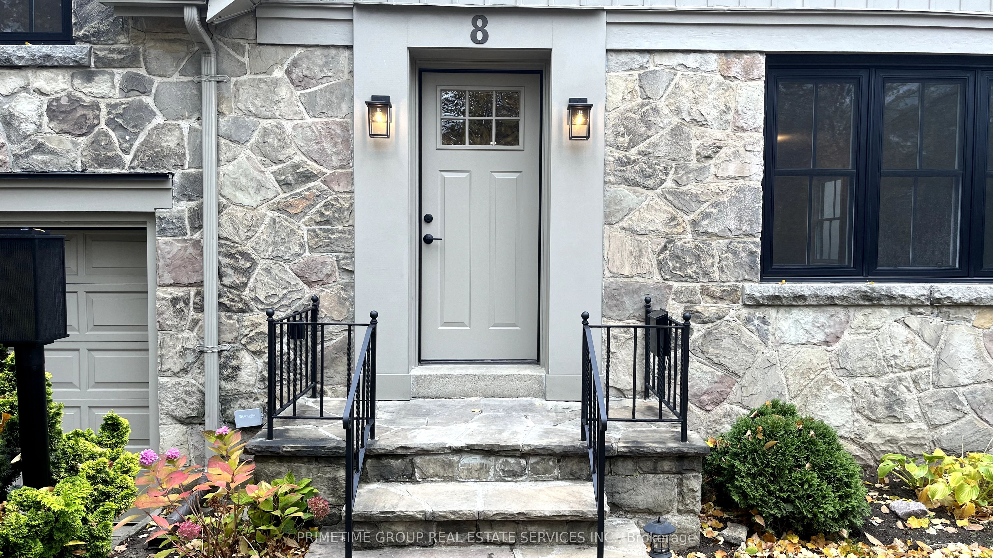 The front entrance of 8 Meadowcrest Road, Etobicoke — stone facade, paneled door and lantern lighting