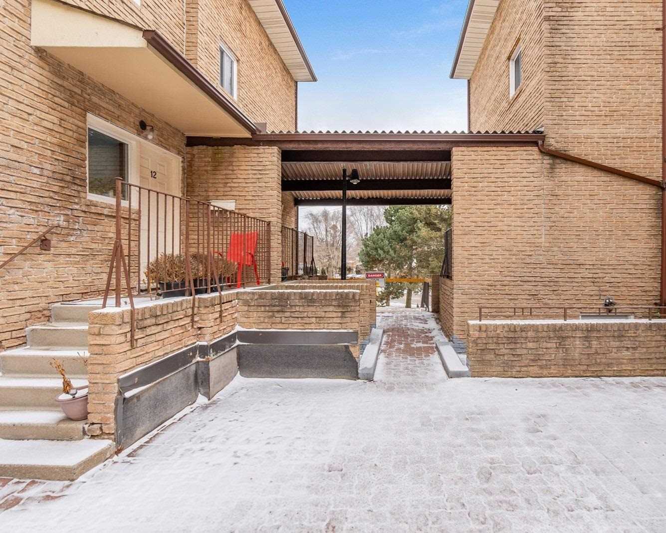 Brick front entrance of the Scarborough Golf Club Road Townhouses community at 91 Muir Drive, Toronto